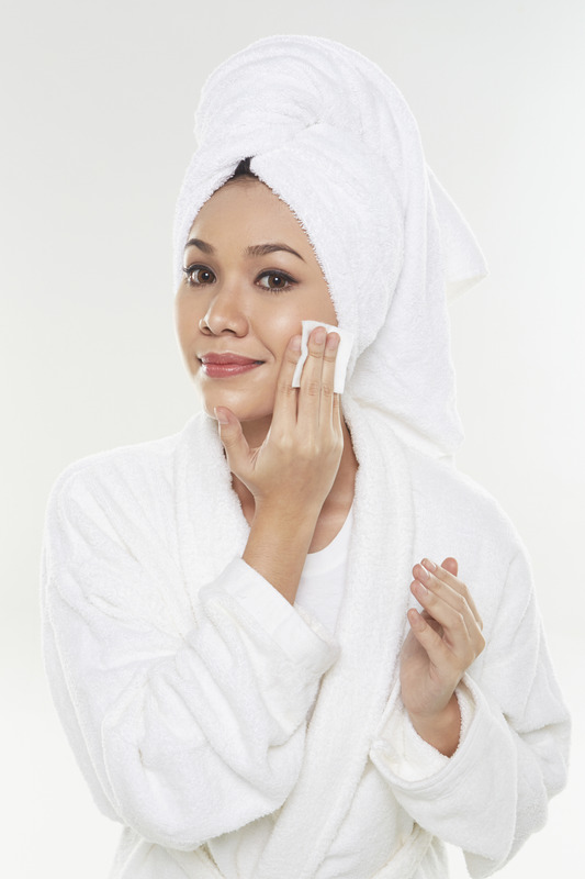 Woman applying facial product